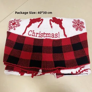 Detail of red and black plaid Christmas tree skirt with reindeer embroidery and white accents