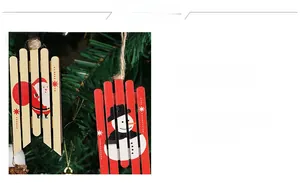 Detail of wooden Christmas ornaments featuring Santa and Snowman hanging on a tree branch