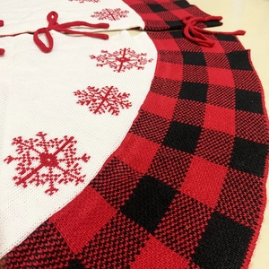 Close-up of red and black buffalo plaid Christmas tree skirt with white snowflake embroidery
