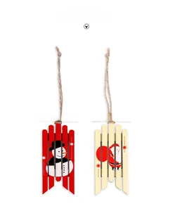 Detail of wooden sled Christmas ornaments featuring Santa and Snowman with twine ropes