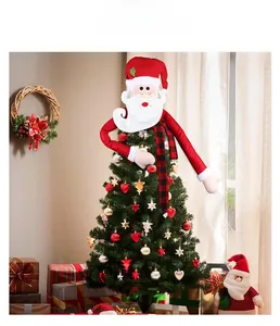 Detailed view of plush Santa Claus tree topper with red scarf on a decorated Christmas tree