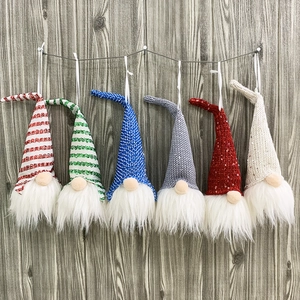 Set of 6 Christmas gnome ornaments with striped hats and white beards on wooden background