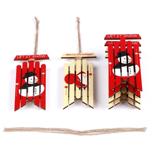 Close-up of wooden sled Christmas ornaments with Snowman and Santa Claus festive patterns