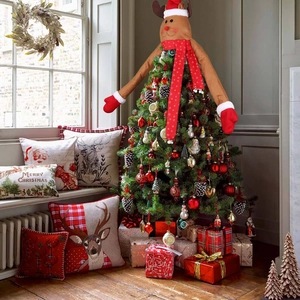 Detailed plush reindeer topper set with Christmas hat, arms and scarf on tree
