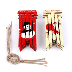 Detail of wooden Christmas ornaments featuring snowman and Santa with hanging jute ropes