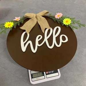 Weight measurement of circular wooden front door hanger with hello sign and floral bow