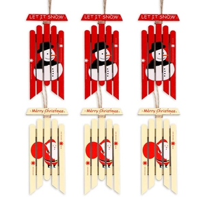 Detailed view of wooden Christmas ornaments featuring Santa Claus and snowman with Merry Christmas text