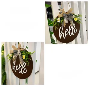 Detail of wooden welcome sign with hello text, burlap bow, and yellow daisies