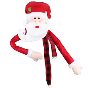 Detail of Santa Claus tree topper featuring red velvet arms and plaid scarf décor