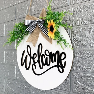 White wooden welcome wreath with sunflower, burlap bow and green leaves for home door decor