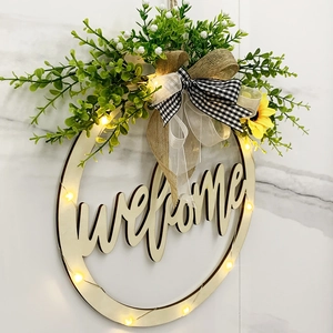 Illuminated wooden welcome sign with sunflower and greenery decor for front door display