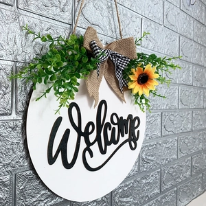 Wooden sunflower welcome sign for front door with greenery and rustic burlap bow decor