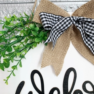 Rustic wooden welcome sign with yellow sunflower accents and burlap bow for home decor