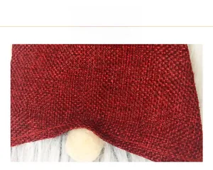 Detail showing high-quality burgundy woven fabric and white plush texture on festive ornament
