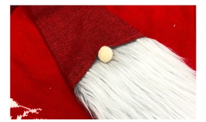 Close-up of a Christmas gnome with plush white beard and red sequin hat detail