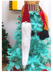 Detailed view of Swedish gnome Christmas tree topper with red felt hat and long white beard