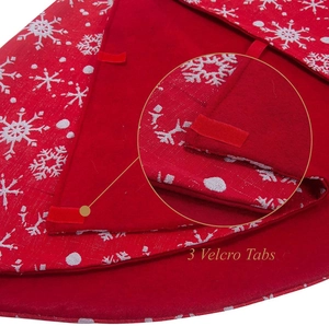 Detail view of red Christmas tree skirt showing three velcro tabs for secure closure