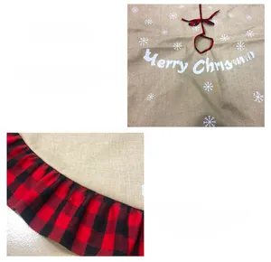 Detail of burlap Christmas tree skirt with red black buffalo plaid ruffle and snowflakes