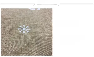 Macro detail of burlap fabric with white snowflake print and rustic vintage texture