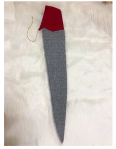 Detail of plush Christmas gnome legs with grey felt and red knitted fabric textures