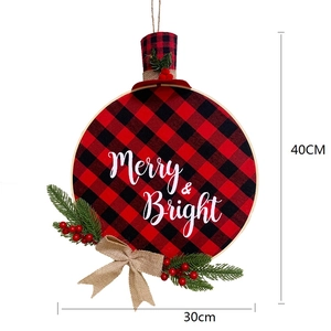 Detail of red and black buffalo plaid Christmas wreath with Merry and Bright text