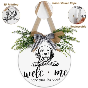 Detail view of round wooden dog welcome sign with interchangeable parts and burlap bow