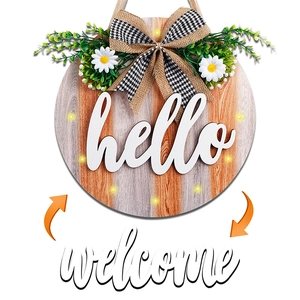 Lighted wooden welcome door sign with hello lettering and decorative floral bow