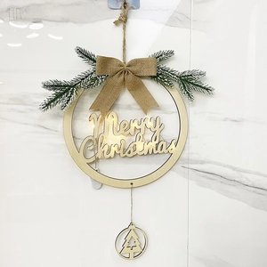 Detail of wooden Merry Christmas wreath with LED lights and burlap bow on marble wall