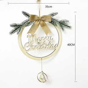 Detail of wooden Merry Christmas wreath with burlap bow and artificial pine branches