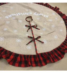 Close-up of snowflake pattern and red black buffalo plaid ruffle on Christmas tree skirt