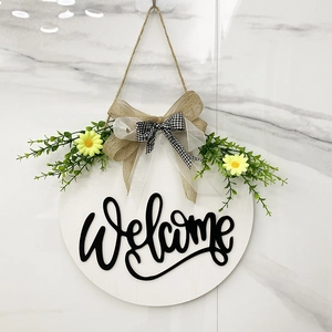 Close-up of wooden welcome sign with daisies and black and white buffalo check bow