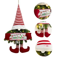 Close-up of gnome Christmas ornament featuring pine needles and warm LED string lights