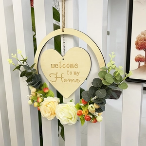 Detail of wooden welcome home heart sign with cream roses and eucalyptus greenery decor