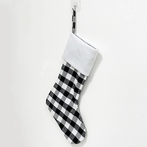 Detail of buffalo plaid Christmas stocking with soft white faux fur trim and hanging loop