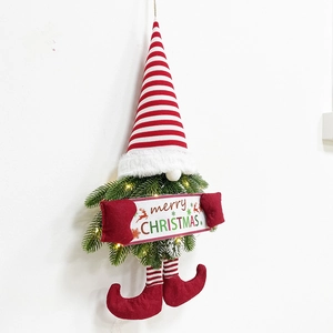 Detail of Christmas wreath featuring a gnome with green pine needles and LED warm lights
