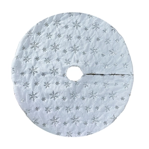 Detail of white plush Christmas tree skirt with shiny silver snowflake sequins