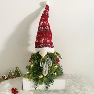 Detail of LED Christmas gnome tree with warm lights and festive knitted reindeer hat