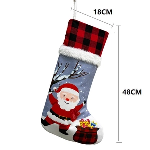 Christmas stocking with Santa Claus print, buffalo plaid top, and plush white faux fur trim