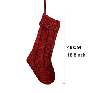 Classic red knitted Christmas stocking 48cm with cable stitch and hanging loop on white backdrop