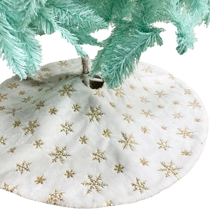 Close-up of plush white Christmas tree skirt with golden sequined snowflake patterns