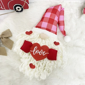Valentine's Day gnome plush with red love heart on white faux fur background
