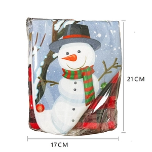 Detailed view of snowman Christmas stocking hanging ornament with red plaid background