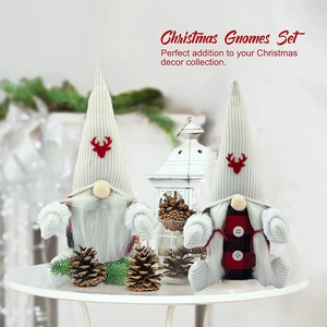 Close-up of two Christmas gnomes with red deer motifs and red-black checkered outfits