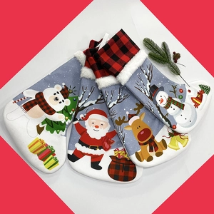 Flat lay of four Christmas stockings featuring Santa, reindeer, snowman and polar bear characters