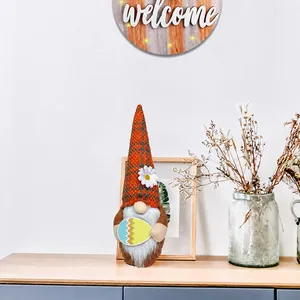 Close-up of Easter gnome with orange plaid pattern and colorful egg in a home setting