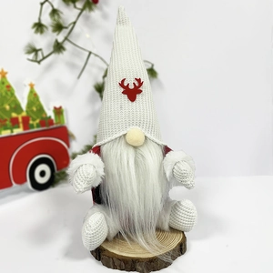 Christmas gnome plush with red antlers and plaid body on a wooden base decor