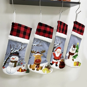 Detail of four Christmas stockings with buffalo plaid cuffs and plush white faux fur trim