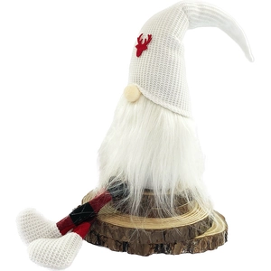 Christmas gnome doll with red reindeer hat and plaid legs sitting on wood