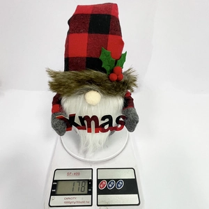 Close-up showing a 178g Christmas gnome doll with red buffalo plaid hat and Xmas sign