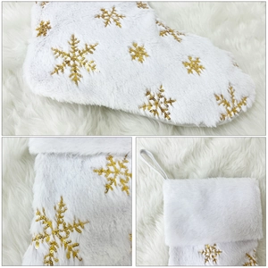 White faux fur Christmas stocking with gold sequin snowflakes for holiday decor